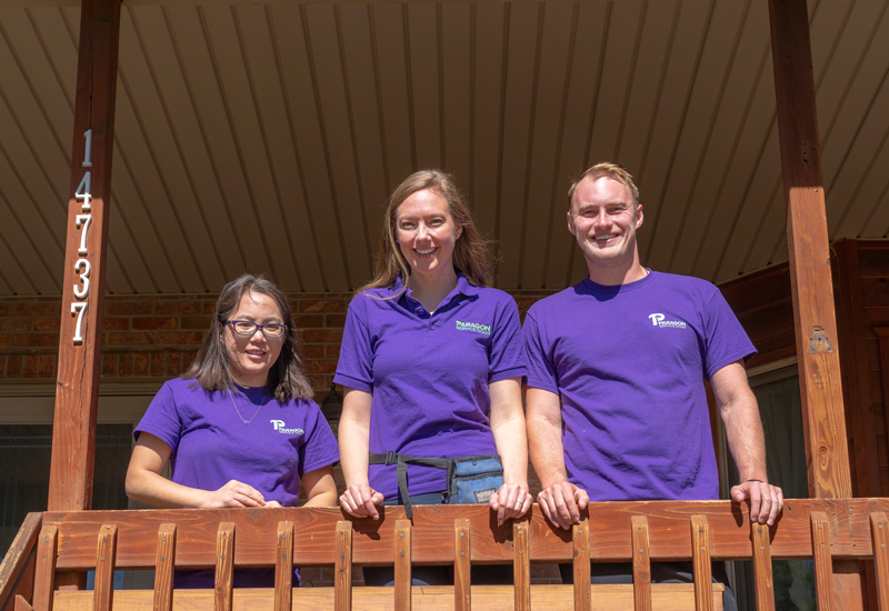 Three employees of Paragon Service dogs in purple tshirts
