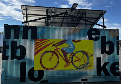 a poster of a person riding a bike on a metal wall