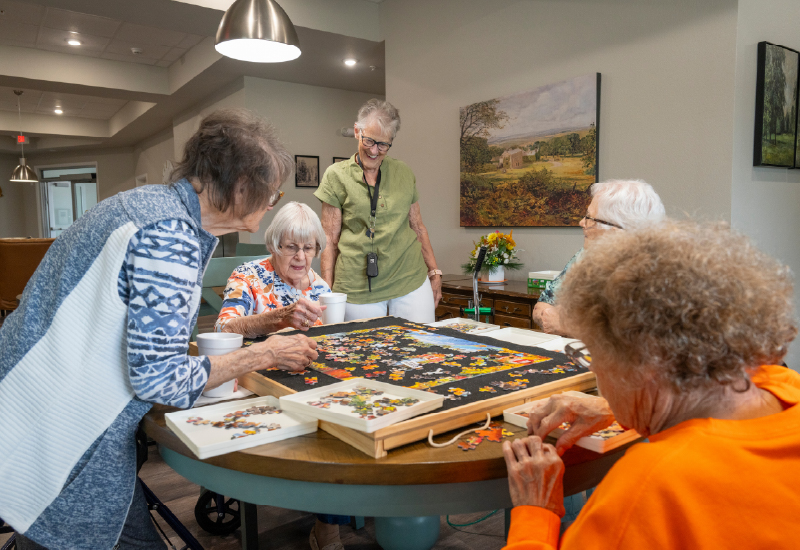 A group of women doing a puzzle.