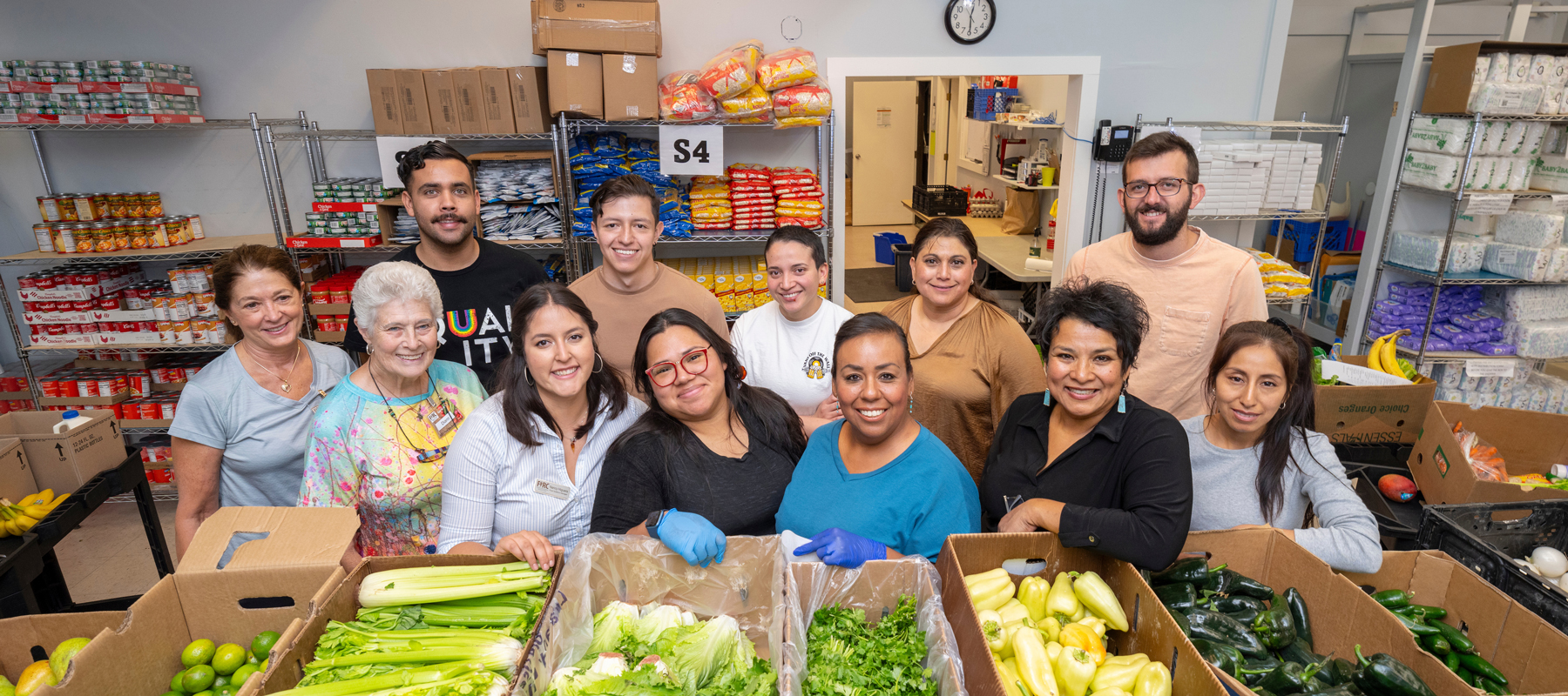 A group of volunteers around a table of food at FIRC