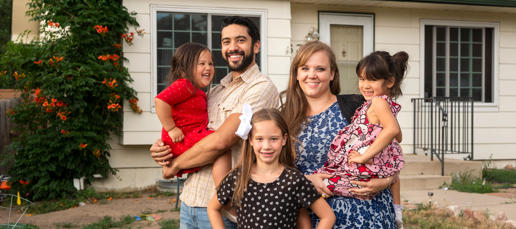 A family standing in front of a house