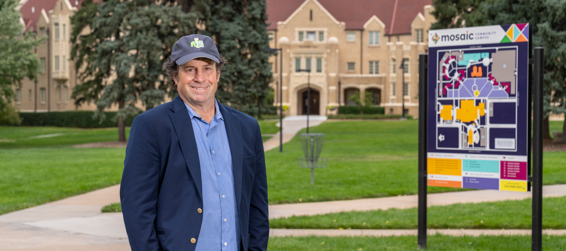 A photo of Aaron Miripol standing in front of a building