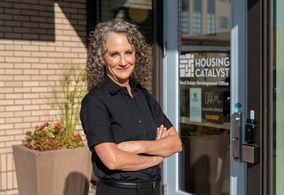 Julie Brewen in front of Housing Catalyst building