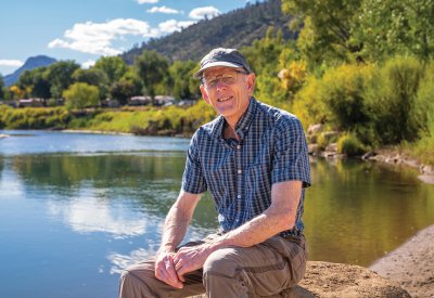 Dan Hunt sitting next to a river