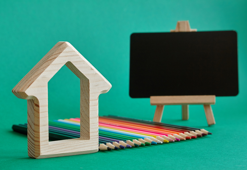 A wooden home and a small chalkboard