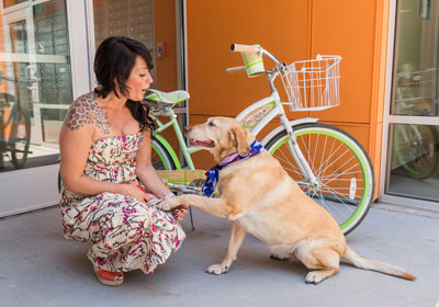 a woman with a dog outside Northfield Apartments