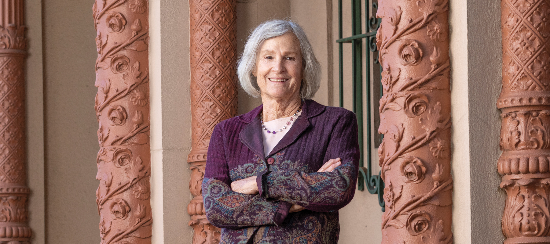 Grace Buckley standing next to ornate pillars