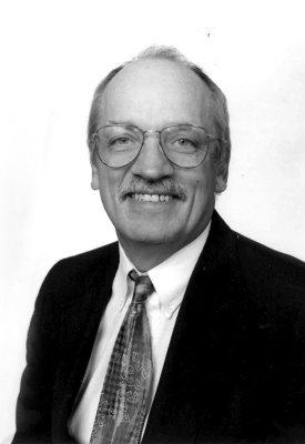 a black and white photo of Dave Barba smiling