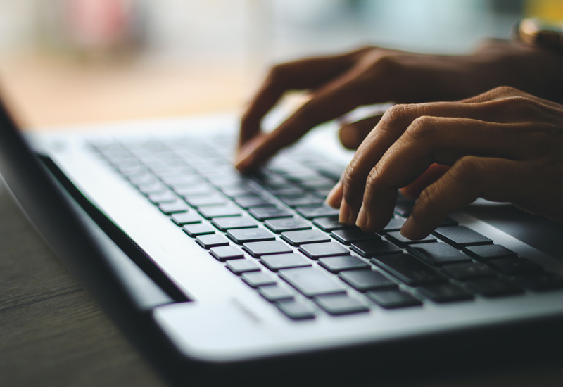 hands typing on a keyboard