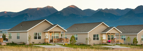 A grouping of houses set against mountains