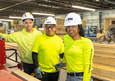 Workers in yellow shirts and hard hats at Fading West