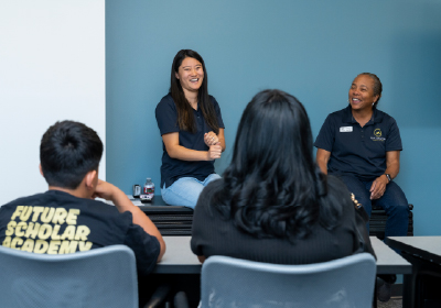 Four people chatting in a blue room