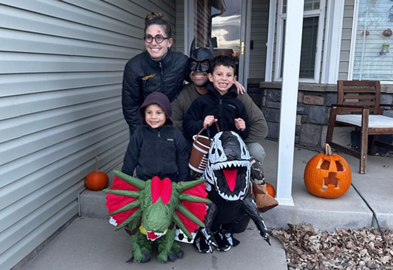2025 Good to be home contest photo winner - a family on a porch dressed up for Halloween