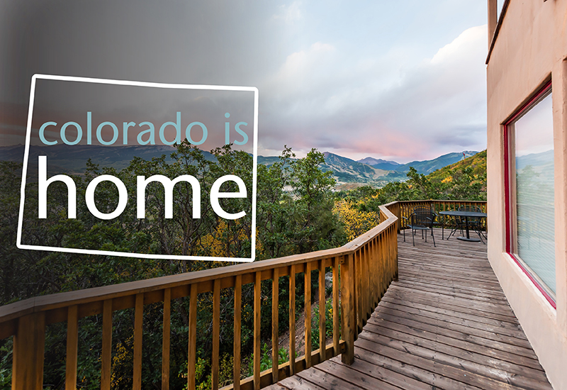 An image of a deck facing mountains and words that read colorado is home