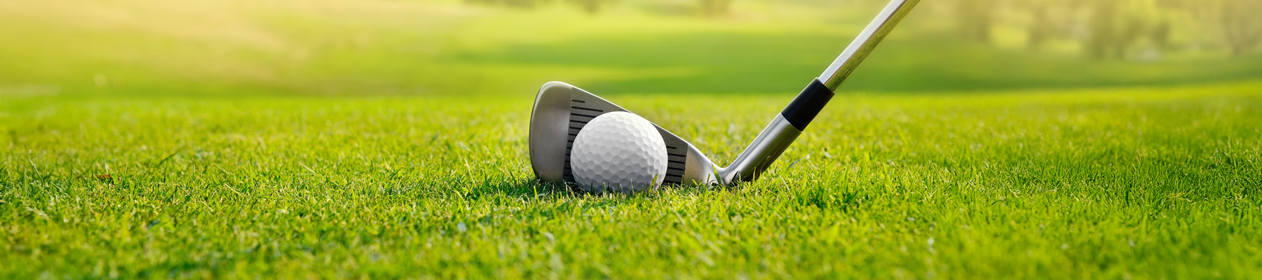 A golf club hitting a golf ball