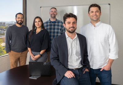 Zach Neumann and Sam Gilman and a group of others in an office