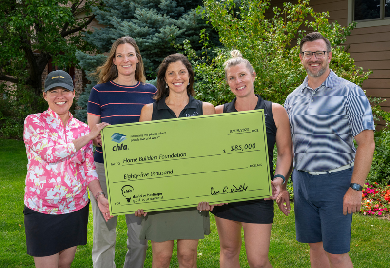 Rocky Mountain Microfinance Institute with CHFA Execs holding check