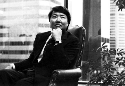a black and white photo of Rodger Hara at a desk