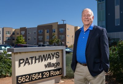 William Wade in front of a building with blue sky