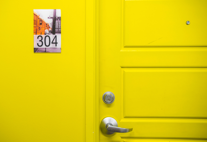 A yellow door with a 304 nameplate