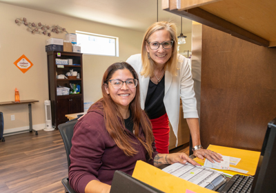 Two people working at a desk in an office