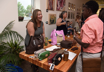 a woman selling purses