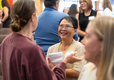 Two people talking to each other at a community gathering