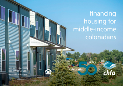 A light blue multifamily building with trees out front