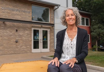 Betsey Martens sitting in front of a Community Center