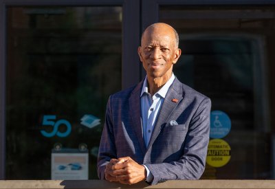 Roy Alexander in front of a building