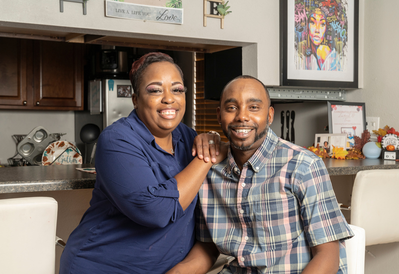 Terri and Lamont, CHFA Homeowners smiling in their kitchen