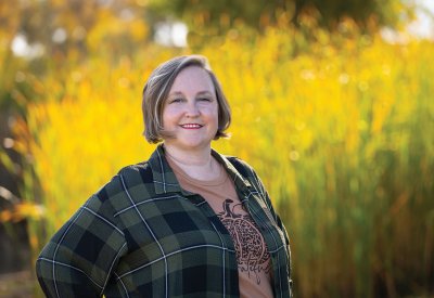 Dawn Melgares standing in front of fall foliage