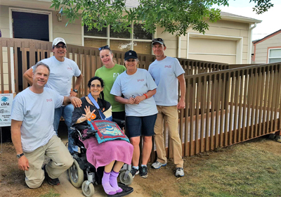 a group of volunteers with ramp recipient