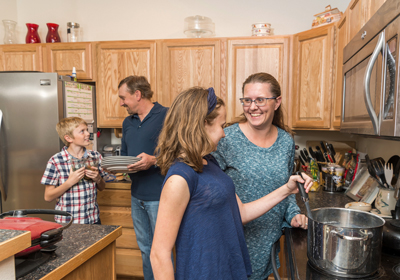 A family cooking dinner together in their kitchen