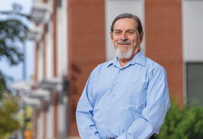 John Parvensky smiling while in front of a building