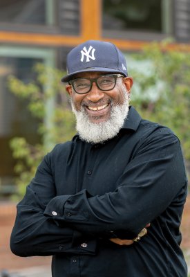 Hassan Latif in a Yankees baseball cap and black shirt