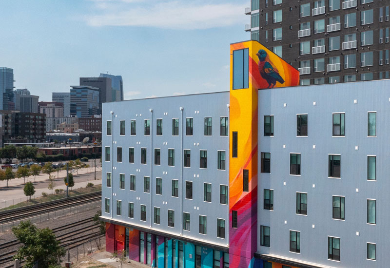 External image of a multifamily property in Denver area with a colorful feature and artwork in the middle