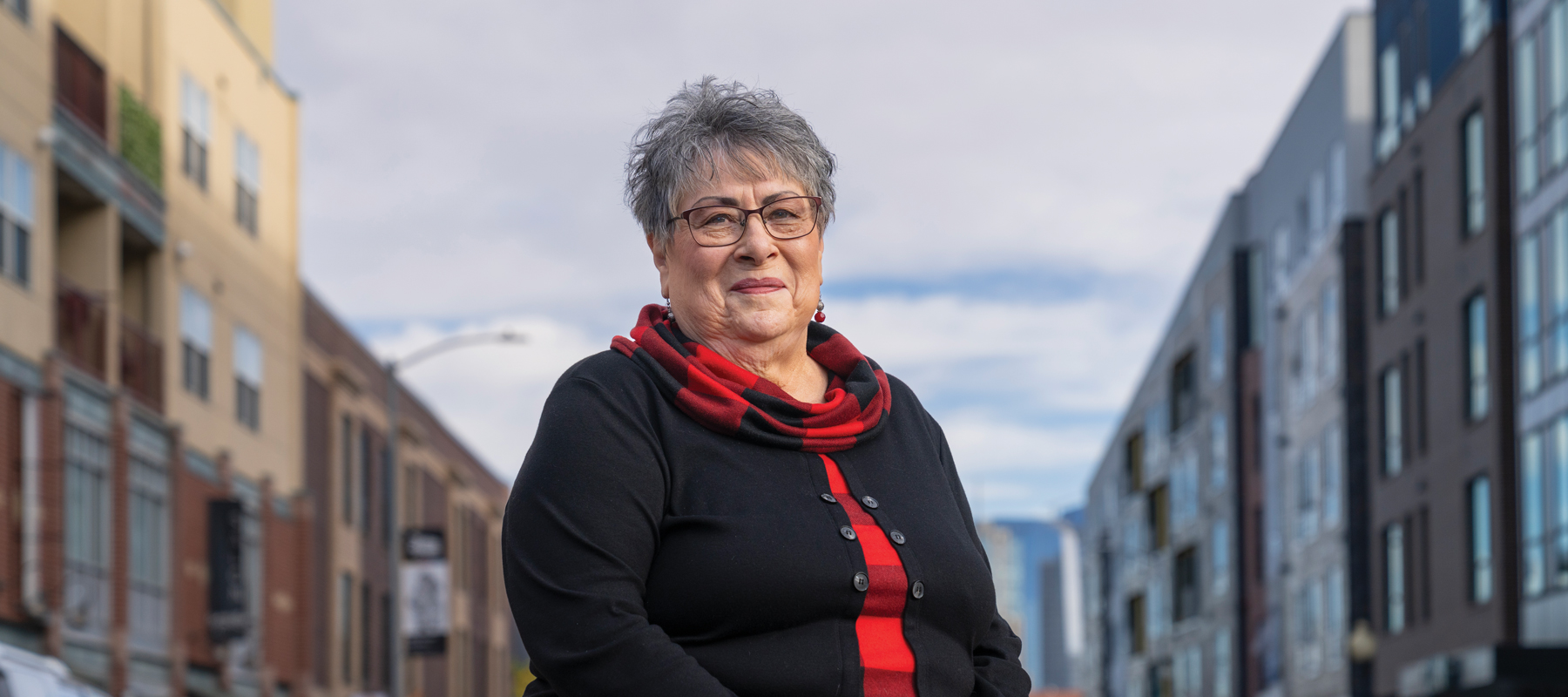 Veronica Barela standing between two buildings