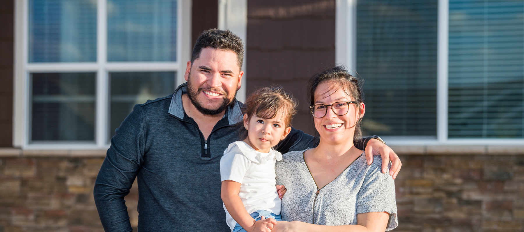 David and Joana with their child in the kitchen