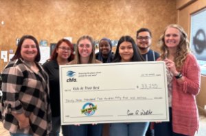 Presenting the Like it Forward big check to Kids at their Best