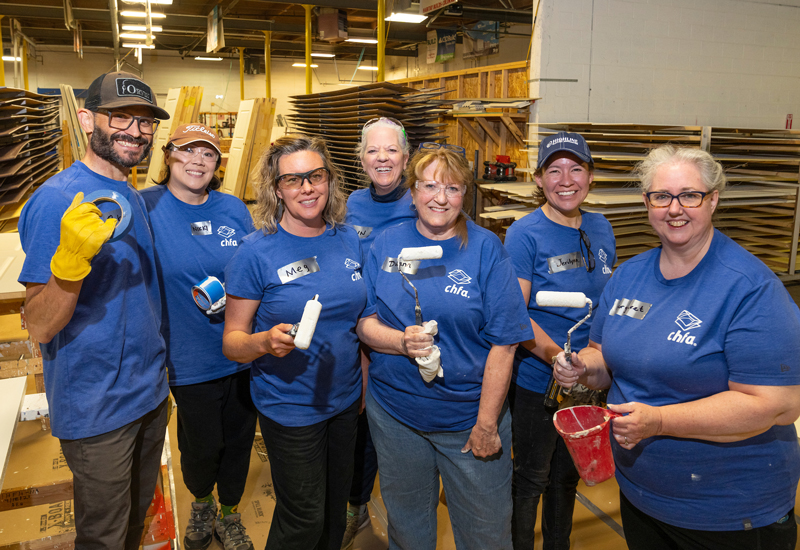 CHFA staff in teal volunteer shirts 