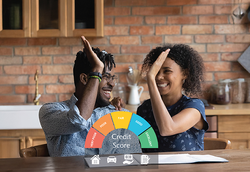 Two people sitting at a table high-fiving with a credit score graphic super-imposed in front of them