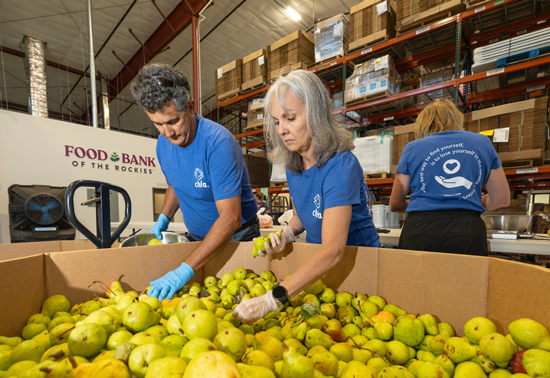 CHFA volunteers sorting food at Food Bank of the Rockies facility