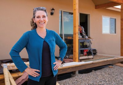 Laura Lewis Marchino standing in front of a home under construction