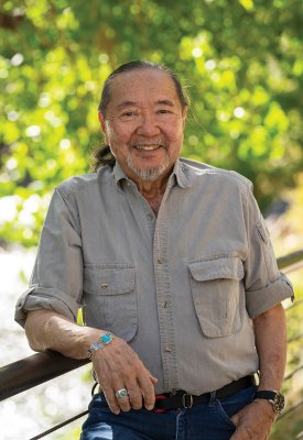 Rodger Hara standing in front of trees smiling