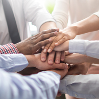 several sets of hands piled on top of each other