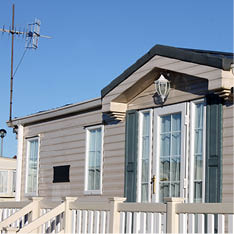 Exterior of luxurious modern caravan with blue sky background 